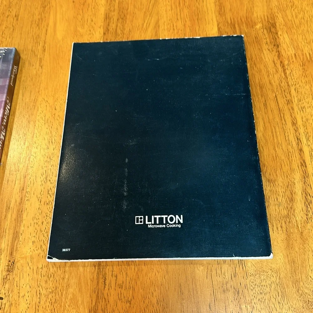 2- Microwave cookbooks. One is still in plastic by Whirlpool. The other Litton